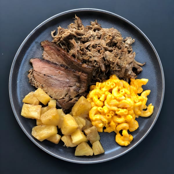 Bill's Grill Smokehouse BBQ plate with sliced brisket, pulled pork, mac and cheese, and pineapple.